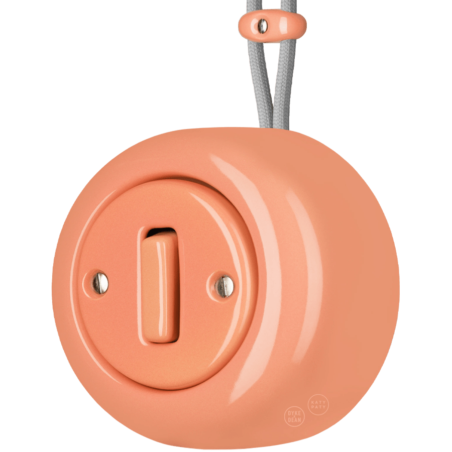 PORCELAIN ROUND SURFACE MOUNTED SLIM BUTTON SWITCH SALMON PINK - DYKE & DEAN